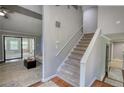 View of staircase connecting floors, with a glimpse of the living room and sliding glass doors at 2926 Swarthmore Dr, Lawrenceville, GA 30044