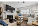 Comfortable living room with fireplace, sectional sofa, and hardwood floors at 508 Vinings Forest Se Ct, Smyrna, GA 30080