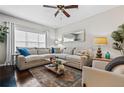 Bright living room featuring a sectional sofa, large window, and a ceiling fan at 508 Vinings Forest Se Ct, Smyrna, GA 30080