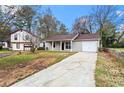 Lovely home with a long driveway and a well-manicured lawn at 1056 Park West Ct, Stone Mountain, GA 30088
