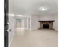 Bright living room with tile floors and a stone fireplace, with sliding glass doors to the yard at 1056 Park West Ct, Stone Mountain, GA 30088