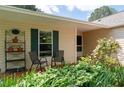 Inviting front porch with seating and lush landscaping, offering a cozy outdoor space at 217 Colemans Bluff Dr, Woodstock, GA 30188
