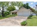 Charming single-story home with a well-kept lawn and an attached two-car garage at 217 Colemans Bluff Dr, Woodstock, GA 30188