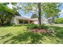 Single-story home with an attached two-car garage and a beautifully landscaped front yard at 217 Colemans Bluff Dr, Woodstock, GA 30188