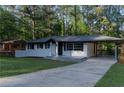 Charming one-story home with a covered carport, newly painted exterior, and a well-manicured lawn at 2720 Cavalier Dr, Decatur, GA 30034