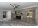 Open-concept living room and kitchen area with hardwood floors, new windows and lots of natural light at 2720 Cavalier Dr, Decatur, GA 30034