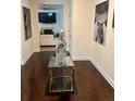 Elegant entryway featuring hardwood floors, modern art, and a view into the open-concept living space at 5637 Valley Loop, Fairburn, GA 30213