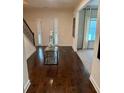Inviting foyer featuring gleaming hardwood floors, staircase, and a decorative console table at 5637 Valley Loop, Fairburn, GA 30213