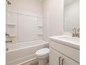 Bright bathroom featuring a shower and tub combination and single sink vanity at 1979 Deco Dr, Kennesaw, GA 30144