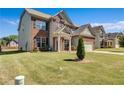 Beautiful two-story home with brick and siding, a well-kept lawn, and a two-car garage at 385 Hinton Chase Pkwy, Covington, GA 30016