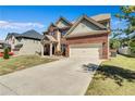 Beautiful brick home featuring an attached two-car garage and manicured front yard at 385 Hinton Chase Pkwy, Covington, GA 30016