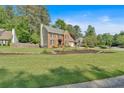 Traditional brick home with a two-car garage and landscaped front yard, set on a spacious lot with mature trees at 4067 Silver Fir Ct, Marietta, GA 30066