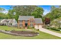 Well-maintained brick home with a two-car garage, landscaped front yard, and inviting curb appeal in a serene setting at 4067 Silver Fir Ct, Marietta, GA 30066