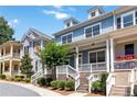 Beautiful townhome exterior showcasing a welcoming porch, tidy landscaping, and classic architectural details at 510 Suwanee Pass Ln, Suwanee, GA 30024