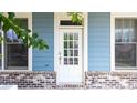 Close-up of a stylish front door with windows and blue siding, creating a welcoming entrance at 510 Suwanee Pass Ln, Suwanee, GA 30024