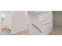 Upstairs hallway with carpet, access to a bathroom, and a view of the staircase at 7139 Brushwood Bend - Lot 42, Lithonia, GA 30058