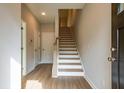 Bright entryway showcasing wood flooring, staircase with white risers, and neutral walls at 1903 Deco Dr, Kennesaw, GA 30144
