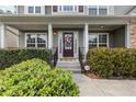 Inviting front porch with a decorative wreath on the front door and manicured shrubbery at 4545 Evandale Way, Cumming, GA 30040