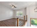 Spacious loft featuring wood floors, large windows, modern railing, and ample natural light at 875 Waterbrook Ct, Roswell, GA 30076