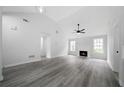 Spacious living room featuring high ceilings, a fireplace, and modern flooring at 1031 Abercorn Way, Douglasville, GA 30134