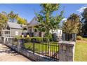 Quaint home featuring an attractive front yard with lush green grass and a charming fenced front entrance at 69 Randolph Ne St, Atlanta, GA 30312