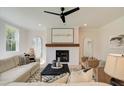 Cozy living room has a white brick fireplace, mantle, and neutral decor at 110 Prescott Manor Dr, Canton, GA 30115