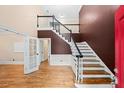 Elegant foyer with hardwood floors, staircase, and view into an office at 1212 Lee Whatley Dr, Lithonia, GA 30058