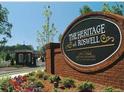 The Heritage at Roswell entrance sign, surrounded by a beautiful flowerbed at 2108 Waters Edge Trl, Roswell, GA 30075