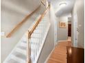 Bright staircase with wooden railing and carpeted steps leading to the upper level at 2108 Waters Edge Trl, Roswell, GA 30075