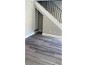Living room with modern flooring and a staircase with decorative wrought iron railing at 31 Villa Se Ct, Smyrna, GA 30080