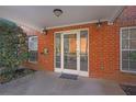 Brick entrance to the building with mailbox, small garden and glass doors at 3302 Dogwood Dr # 123, Atlanta, GA 30354