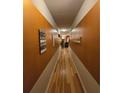 Long hallway featuring wood floors and earth tone colored walls at 7848 Rock Rose Ln, Fairburn, GA 30213