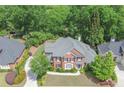 Spacious home with a well-maintained lawn, landscaping, and driveway, nestled in a tranquil neighborhood at 9175 Etching Overlook, Johns Creek, GA 30097