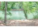 Scenic river view with kayakers and seating area amidst lush greenery; enjoy the peaceful outdoor lifestyle at 9175 Etching Overlook, Johns Creek, GA 30097