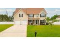 Inviting two-story home with a two-car garage and beautifully manicured front lawn at 13347 Henderson Ct, Hampton, GA 30228
