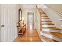 Inviting foyer with hardwood floors, staircase, console table and classic decor at 4004 Edgecomb Dr, Roswell, GA 30075