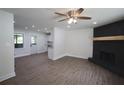 An open floor plan with a fireplace and wood-look floors and recessed lighting at 443 Indian Hills Dr, Dallas, GA 30157