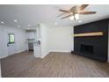 An open floor plan with a fireplace and wood-look floors and recessed lighting at 443 Indian Hills Dr, Dallas, GA 30157