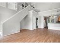 Bright living room with hardwood floors, open staircase, and access to kitchen and dining areas at 1034 Hillsborough Nw, Kennesaw, GA 30144