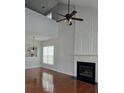Elegant living room with a soaring ceiling, fireplace, and natural light at 1692 Woodsford Nw Rd, Kennesaw, GA 30152