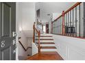 Inviting entryway featuring hardwood floors and elegant staircase with wrought iron spindles at 2268 Limehurst Ne Dr # 120, Atlanta, GA 30319