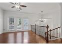 Bright living room with hardwood floors, decorative chandelier, and access to outdoor space at 2268 Limehurst Ne Dr # 120, Atlanta, GA 30319