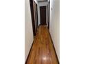 Hallway with wooden floors and neutral walls, offering flow through the home at 260 Amanda Ct, Stockbridge, GA 30281