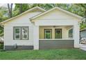 Close-up of a classic white bungalow featuring a cozy front porch with painted brick accents at 39 Wyman Se St, Atlanta, GA 30317
