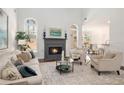 Cozy living room with fireplace, neutral tones, and ample natural light at 448 Cape Ivey Dr, Dacula, GA 30019