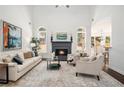 Bright living room with a fireplace, large windows, high ceilings, and a stylish rug at 448 Cape Ivey Dr, Dacula, GA 30019