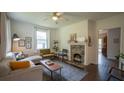 Cozy living room featuring hardwood floors, a decorative fireplace, and ample natural light at 2881 Parrott Nw Ave, Atlanta, GA 30318
