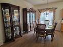 Formal dining room featuring hardwood floors, elegant furnishings, and a large window for natural light at 3828 Dandridge Way, Duluth, GA 30096