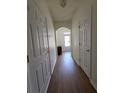 Well-lit hallway featuring hardwood floors and white trim, creating a clean and welcoming transition space at 3828 Dandridge Way, Duluth, GA 30096