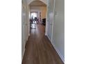 Inviting hallway with hardwood floors, seamlessly connecting living spaces, and leading to the dining area at 3828 Dandridge Way, Duluth, GA 30096